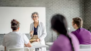 Healthcare professional in a white coat gives a seminar
