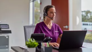 Woman talking in headshot and computer