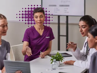 Healthcare professionals discussing a monitor
